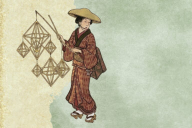 japanilainen nainen kimono-asussaan pitelee suurikokoista himmeliteosta kepin päässä